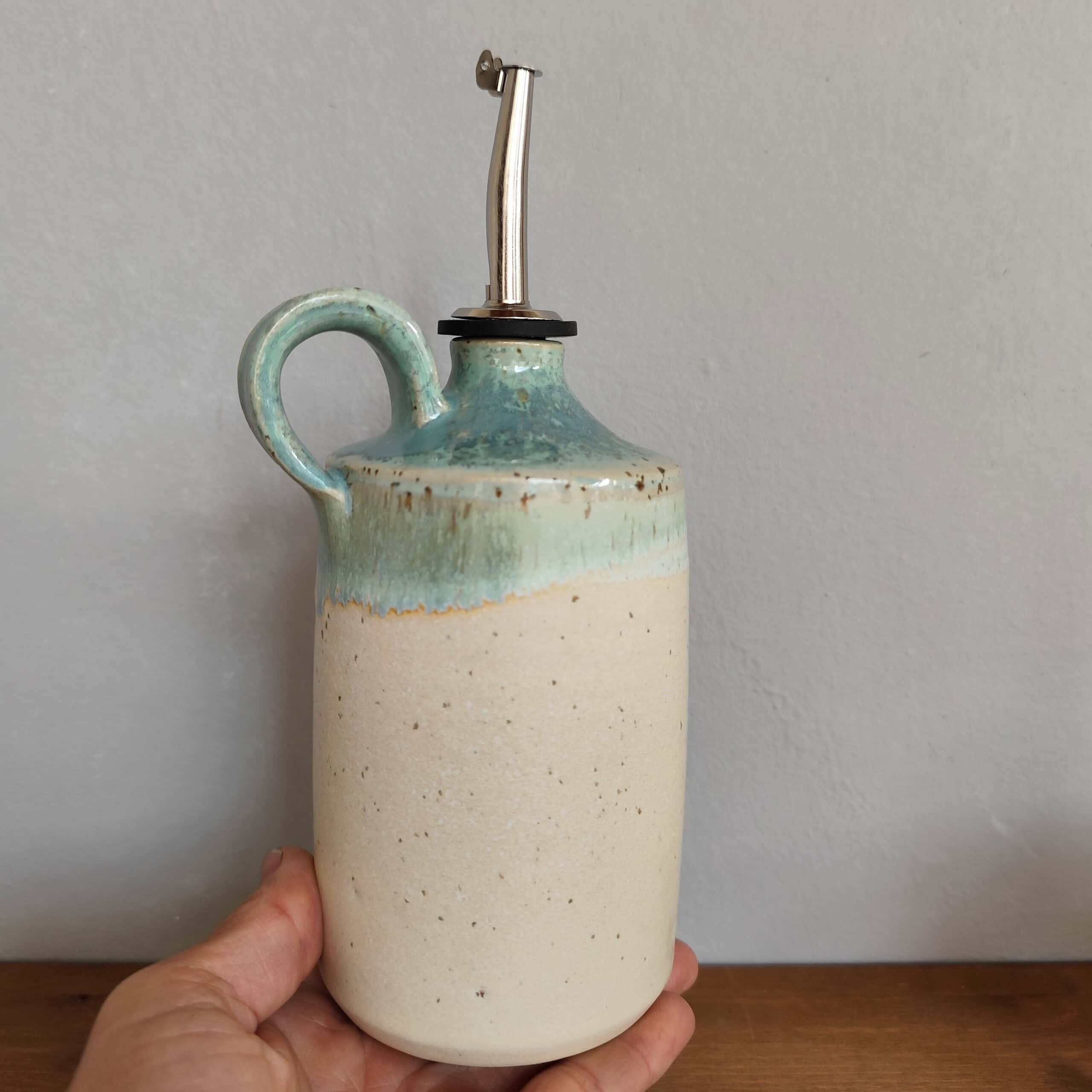 oliera in gres avorio e verde con manico tenuta in mano